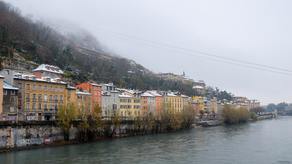 Row Of Colorful Houses On Riverbank In Winter In Grenoble, France.