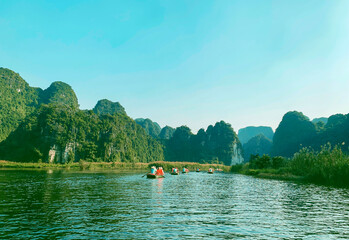 Tourist Boats On Ngo Dong River With Limestone Mountain And Cave In Tam Coc Of Ninh Binh Province, Vietnam.