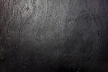 Black stone wall texture for background.