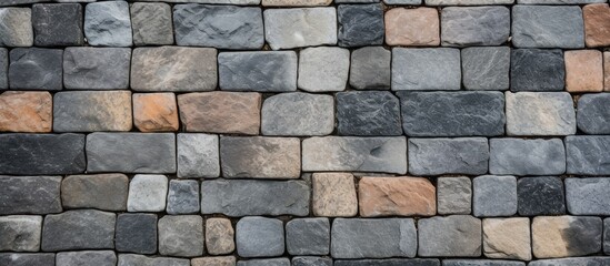 Close up of a brick wall with various colored bricks forming a geometric pattern
