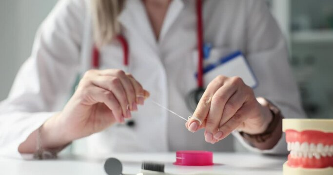 Dentist holding dental floss and jaw concept