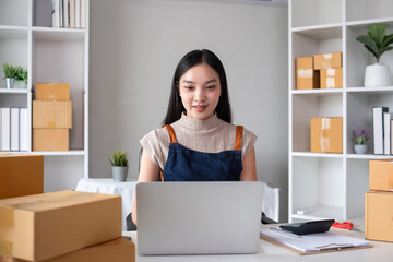 SME business entrepreneurs small in Asia Preparing cardboard boxes in home office Small business operators preparing to ship to customers