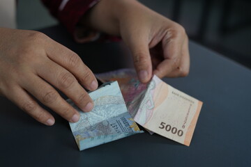 Rupiah banknotes are being counted on the table