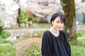 Portrait beautiful japanese woman with short hair sakura tree background