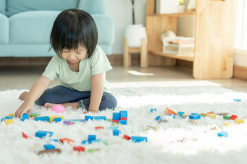 Happy Asian child playing and learning toy blocks. children are very happy and excited at home....