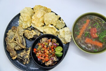 Fried Beef Oxtail with Sambal Balado. Boiled beef oxtail until tender, fried until slightly crispy and served with fresh spicy balado chili sauce.