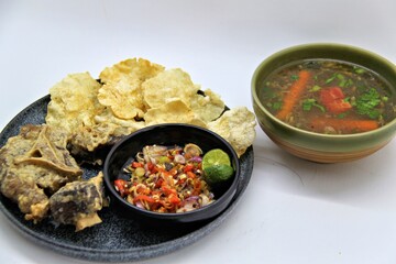 Fried Beef Oxtail with Sambal Balado. Boiled beef oxtail until tender, fried until slightly crispy and served with fresh spicy balado chili sauce.