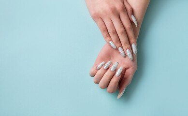 Female hands with blue nail design. Blue nail polish manicure.