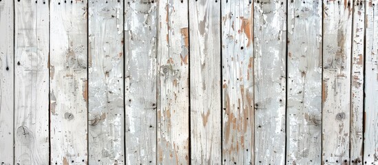 Detailed view of weathered white wooden fence with peeling wood stain