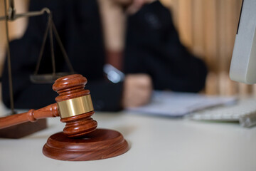 Wooden gavel on table. Female lawyer working on desk. legislation concept