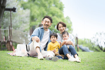 Family having a picnic in the park Image of spring and summer outings and leisure activitiesAsian...