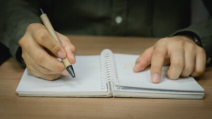 businessman working at work table,home office desk background, checklist writing planning...