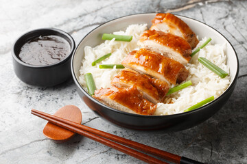 Chinese Food Soy Sauce Chicken or See Yao Gai served with rice and dipping sauce closeup on the...
