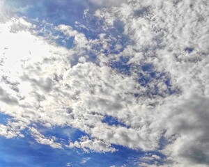 The view of white clouds against a backdrop of blue sky from the top of the Suramadu Bridge.