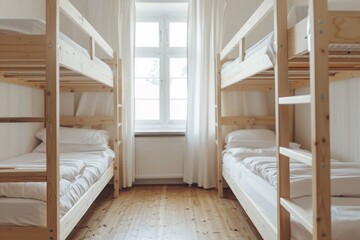 Hostel rooms with bunk wood beds. white bedding set Natural light from the window.