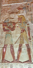 Painted wall relief of Pharaoh Seti I receiving the mummification god Anubis  in the Temple of Seti built in 13th century BC by the Pharoah Seti I near Abydos,Egypt