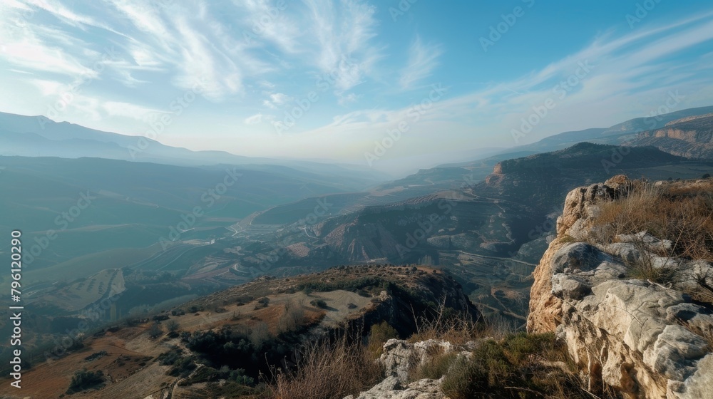 Poster the image shows a panoramic view of mountains captured from a high vantage point. the rugged peaks a