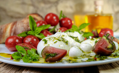 Photo of food, mozzarella with tomatoes, spices, and olive oil, on a large plate, unusual background, restaurant menu, homemade food, unusual picture.