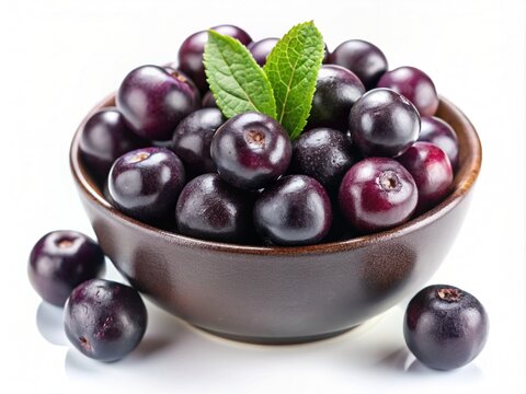 Close-Up Of asai berries and green leaves in bowl  isolated on white Background, top view. Super Food. Concept of healthy food