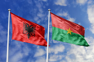 3d illustration. Albania and Burkina Faso Flag waving in sky. High detailed waving flag. 3D render. Waving in sky. Flags fluttered in the cloudy sky.