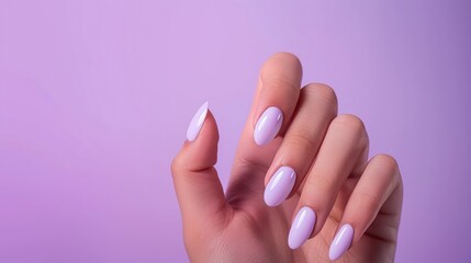 Woman's hand with purple nail art design on gray background