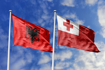 3d illustration. Albania and Tonga Flag waving in sky. High detailed waving flag. 3D render. Waving in sky. Flags fluttered in the cloudy sky.