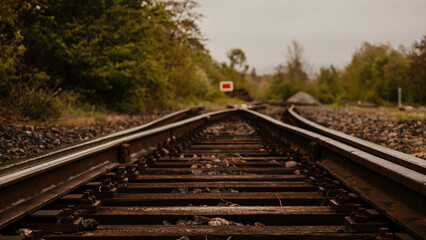 Railway tracks in the countryside. Selective focus with shallow depth of field.