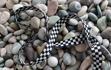 A curved ribbon on the colored stones symbolizing a racing track concept stock photo
