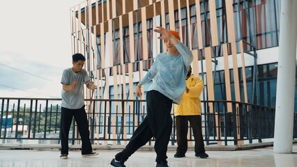 Hip hop team dance break dance while multicultural friend surrounded and clapping hands to cheer or...