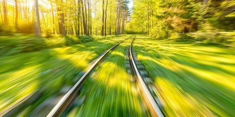  A train is traveling down a track through a lush green field. The train is blurry, giving the impression of motion. The scene is peaceful and serene, with the train © Дмитрий Симаков