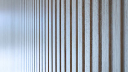 Slatted walls in the house. Closeup of vertical lattice wall with faux wood-like material for modern home decoration in side view with blurred copy space and selective focus.