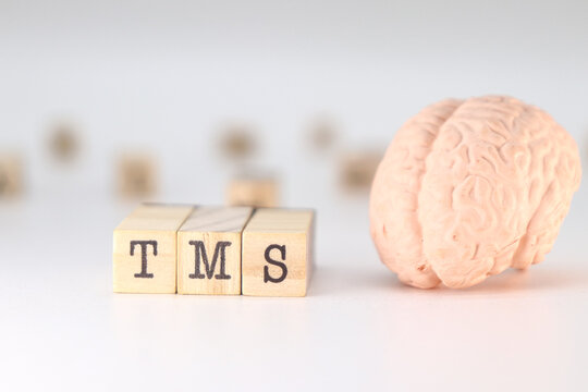 TMS Acronym Transcranial magnetic stimulation concept with brain on white background