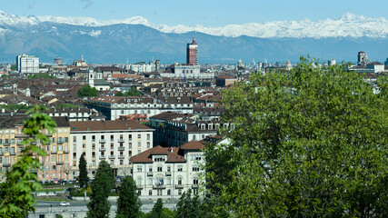 Fototapeta na wymiar Views of the city of Turin surrounded by snow-capped mountains