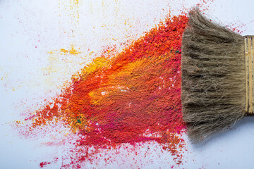 Paint brush and colorful holi powder on white background. festival concept