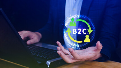 B2C, Business to customer marketing strategy concept. Businessman use laptop with virtual B2C icon...