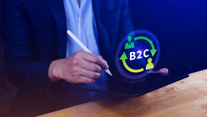 B2C, Business to customer marketing strategy concept. Businessman use laptop with virtual B2C icon...
