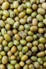 Uncooked, green mung beans background. Dry mung beans grains. Top view. Close-up