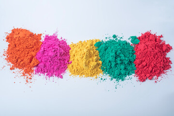 Pile of multicolored holi powder isolated on white background.