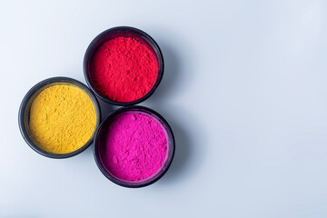 Colorful holi powder in a bowl isolated on white background.