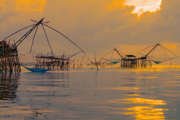 Yor Yak or Thai giant fishing gear with golden morning light, and beautiful sunrise scenery at...
