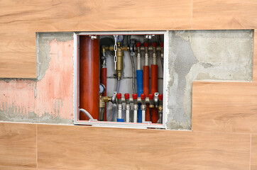 Hidden plumbing and heating communications in the plumbing cabinet.