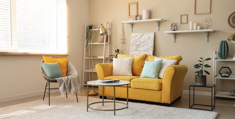 Stylish living room with yellow sofa, armchair and coffee table