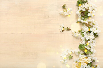 Fototapeta na wymiar Beautiful blossoming branch on beige wooden background