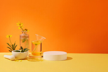 Background for advertising cosmetic of calendula extract with empty podium, glassware and fresh...