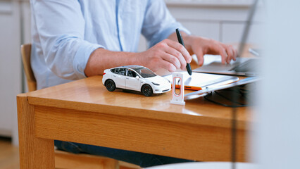 Car design engineer working on car prototype for automobile business at home office. Automotive...