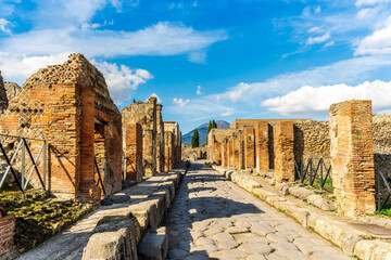 ancient buildings and walls in archeological excavation In Pompeii , Italy. Streets and historical monuments of antique town near Naples in Campania