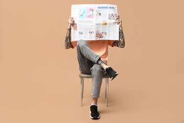 Man with newspaper on beige background