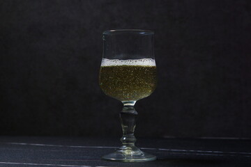 ワイングラスに注がれて黄金色に輝く白ワイン
