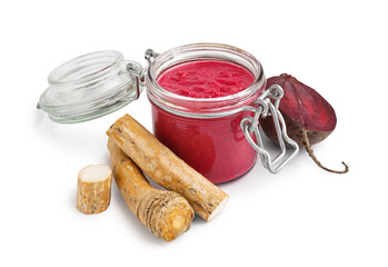 Horseradish sauce with beet in jar and piece of beet on white background