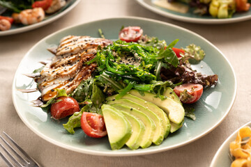 Japanese cuisine concept. Salad of eel, avocado pieces and chuka seaweed served on a plate in a restaurant